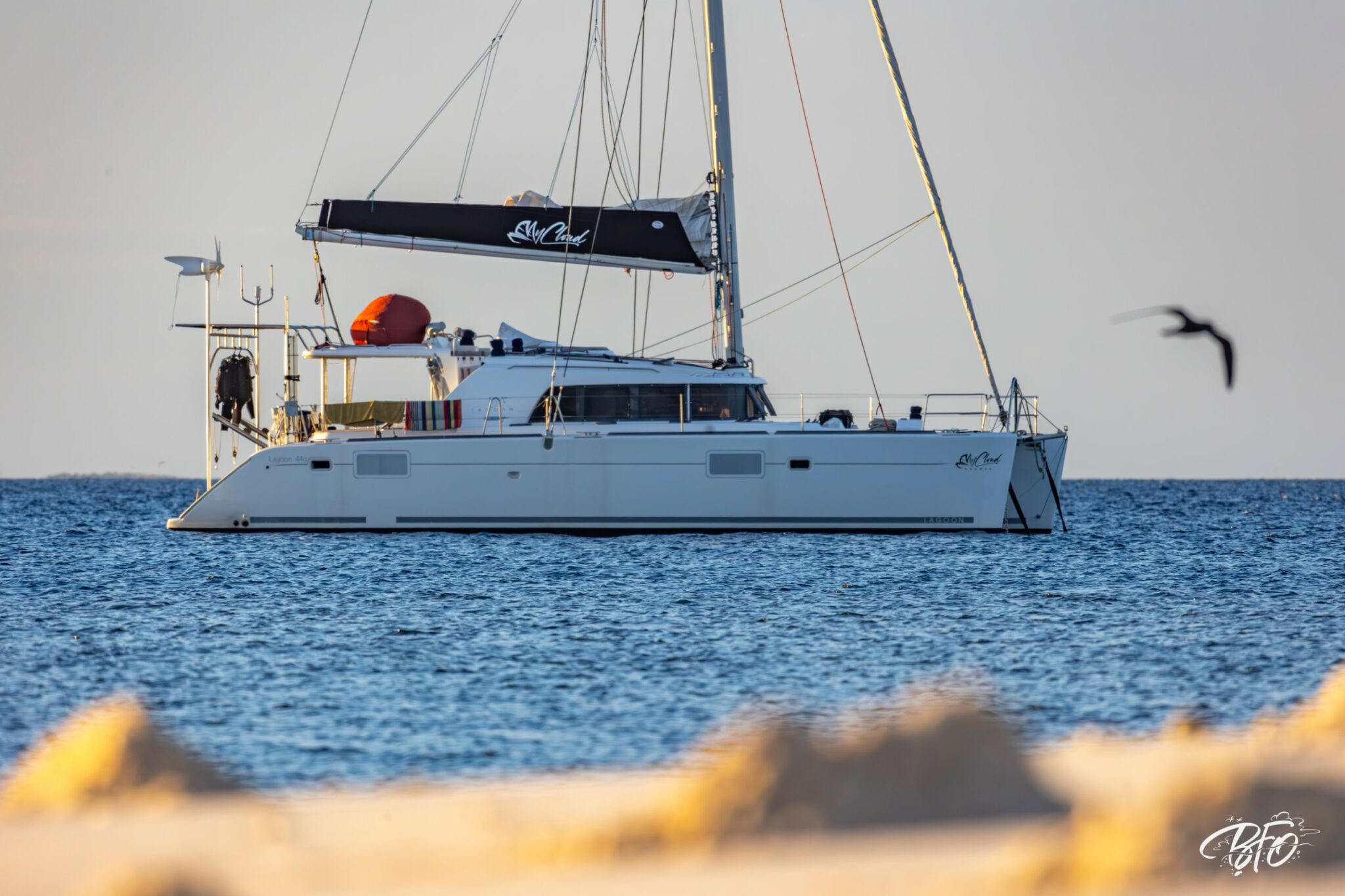 The Lagoon 440 catamaran myCloud at anchor, calm sea